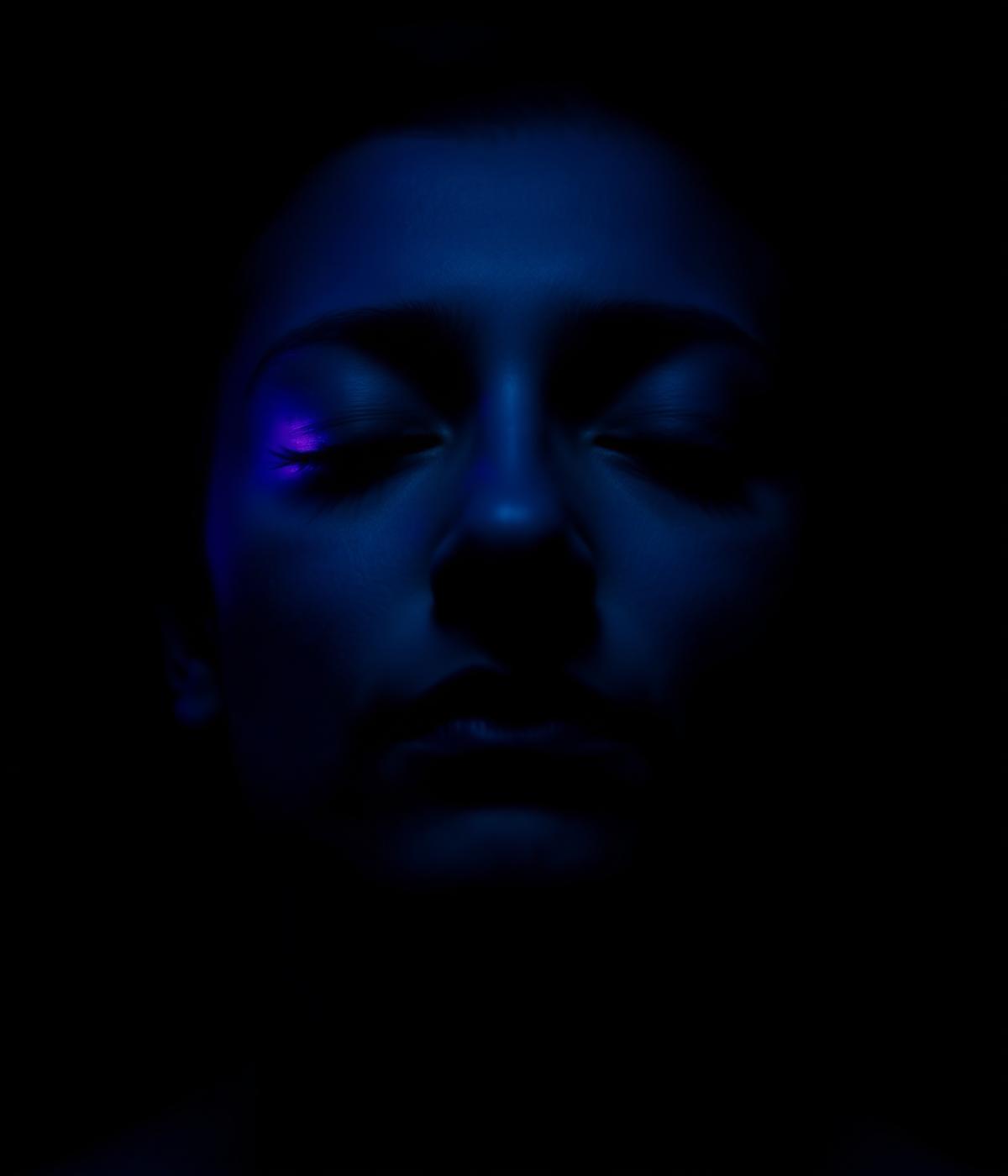 Breathwork practitioner in low light
